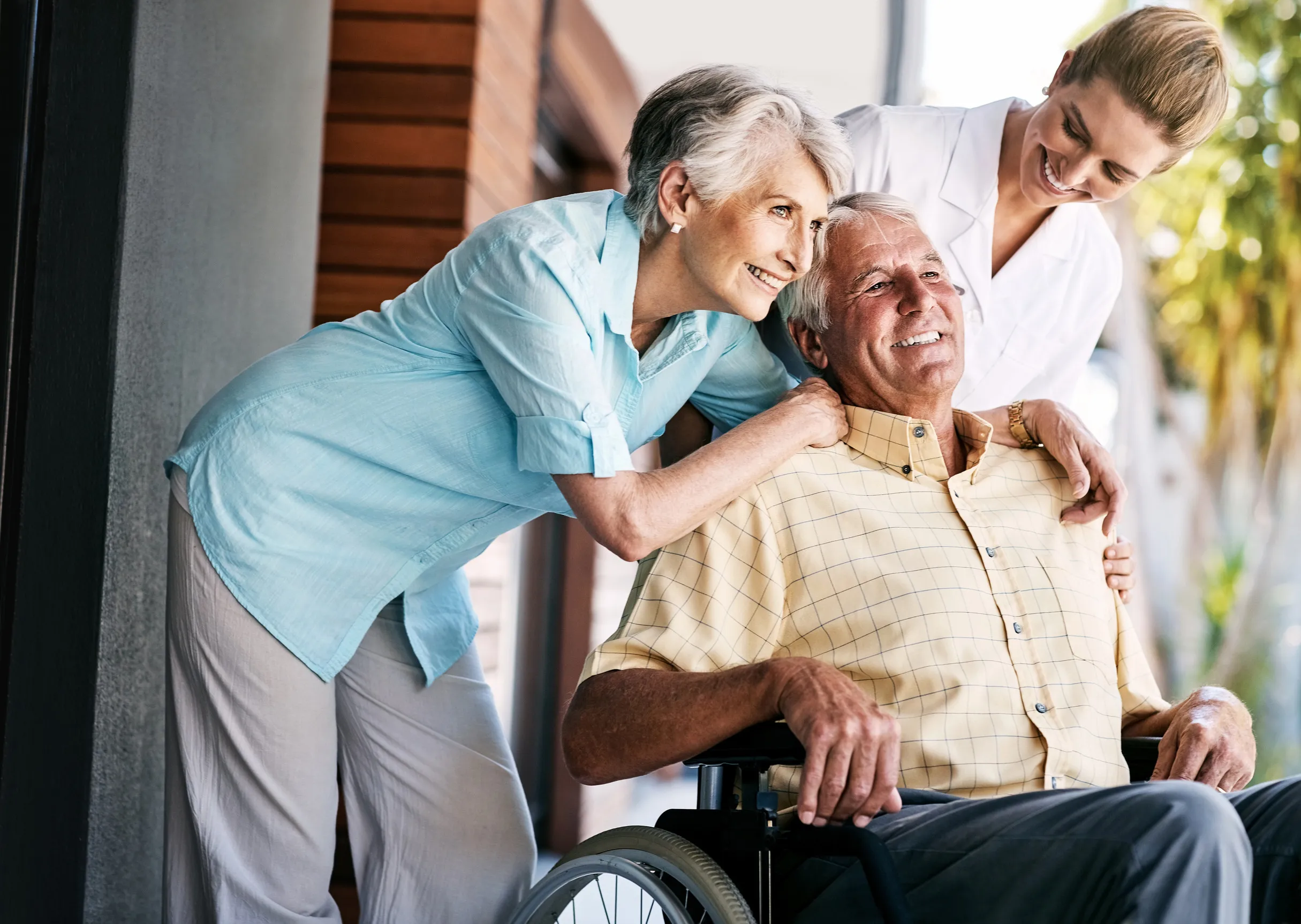 Were all here for you my dear. a senior couple and a nurse outside a retirement home